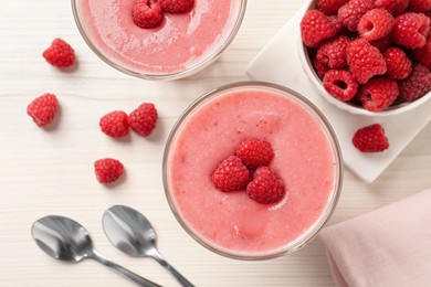 Photo of Delicious raspberry mousse on white wooden table, flat lay