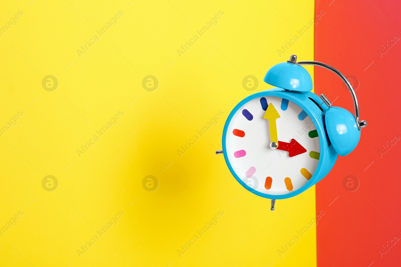 Photo of Alarm clock on color background. Space for text