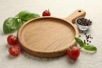 Photo of Cutting board, basil, spices and tomatoes on white textured table. Space for text