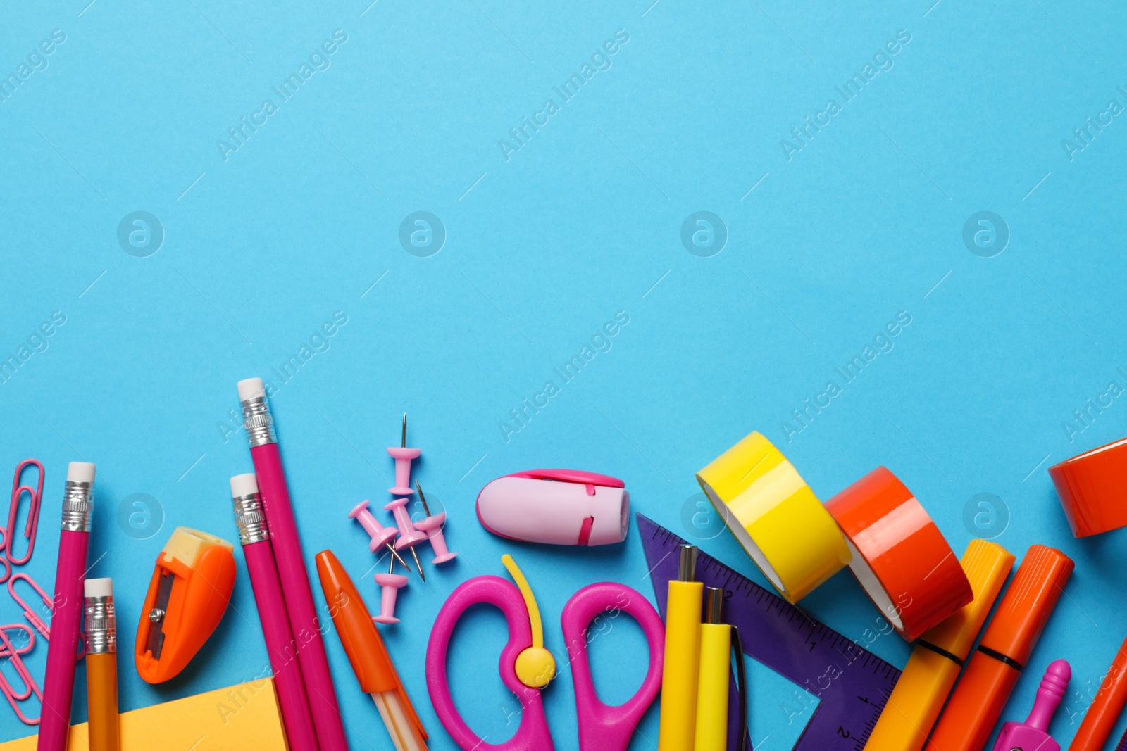 Photo of Flat lay composition with different stationery on light blue background, space for text