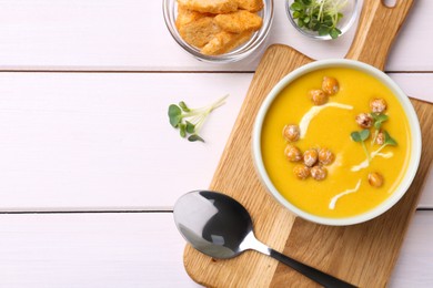 Delicious cream soup with chickpeas on white wooden table, flat lay. Space for text