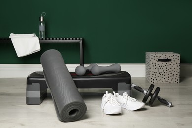 Photo of Step platform and different sports equipment indoors