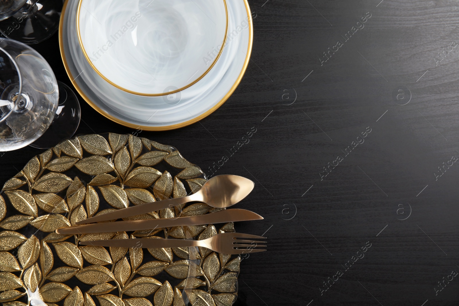 Photo of Elegant table setting and space for text on dark background, top view