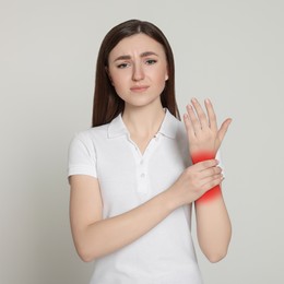 Image of Woman suffering from rheumatism on light background