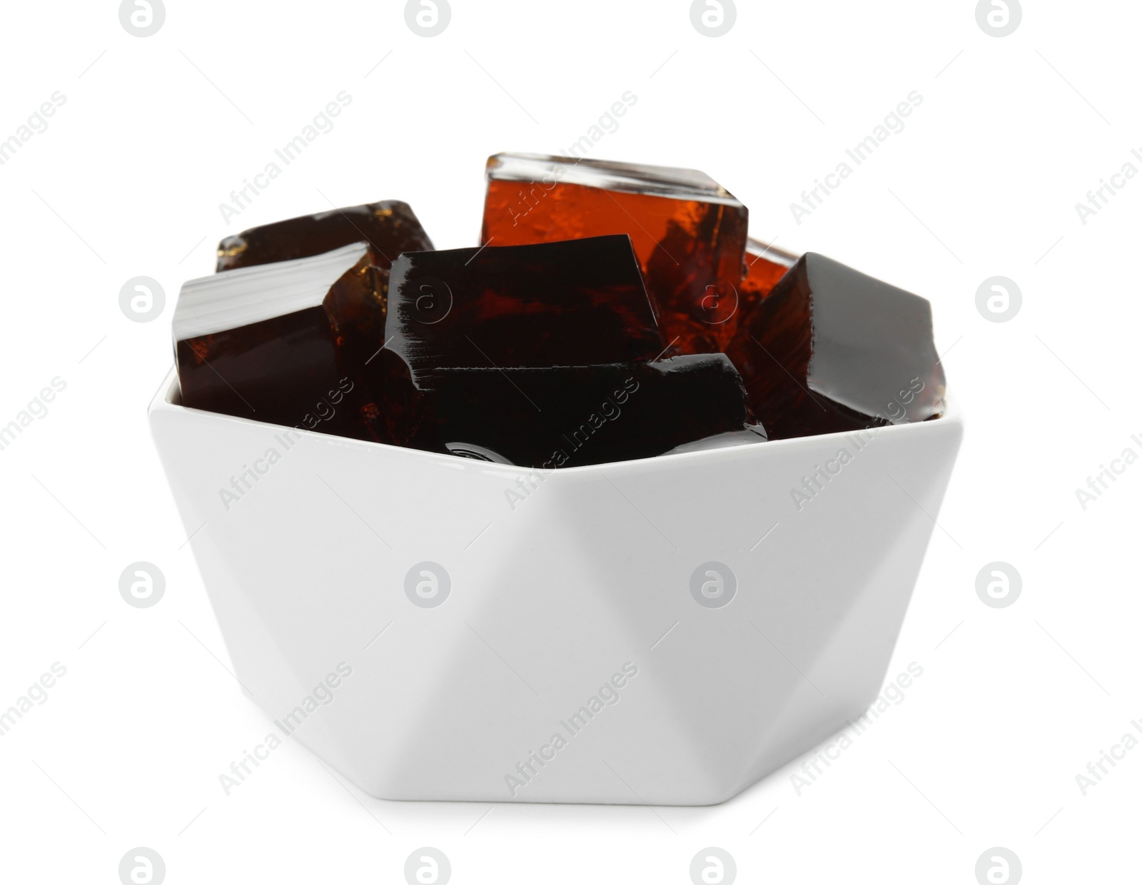 Photo of Delicious grass jelly cubes in bowl on white background