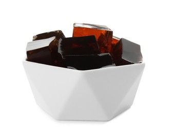 Photo of Delicious grass jelly cubes in bowl on white background