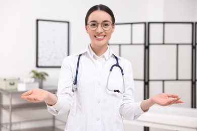 Medical consultant with glasses and stethoscope in clinic