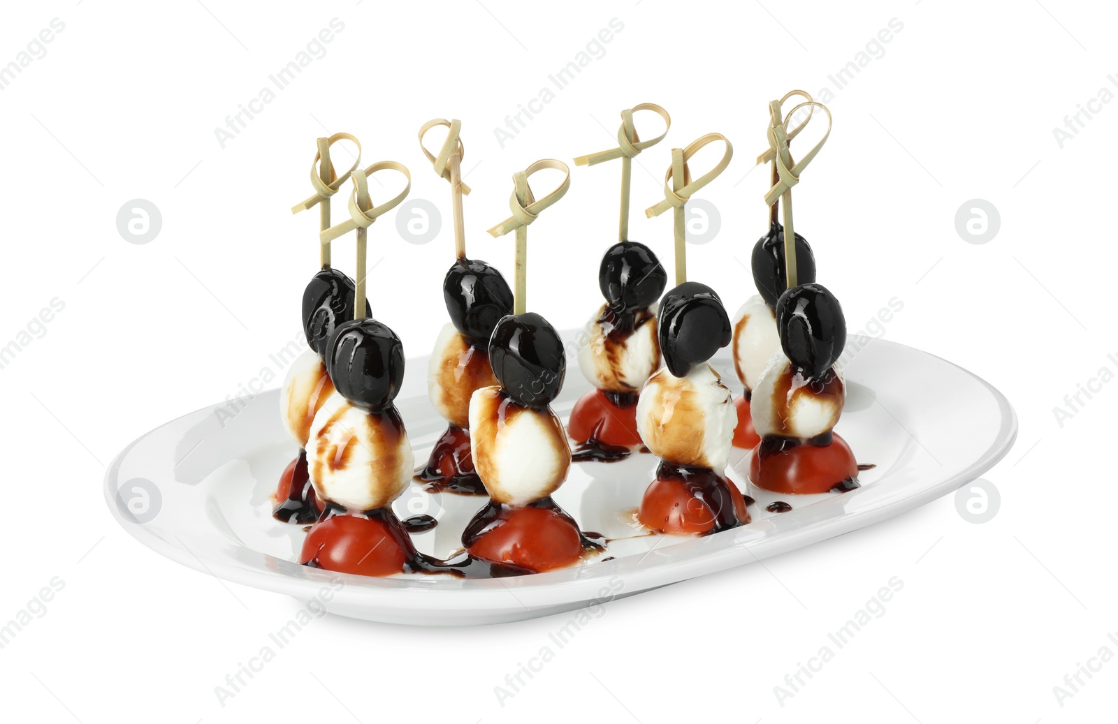 Photo of Tasty canapes with black olives, mozzarella and cherry tomatoes isolated on white