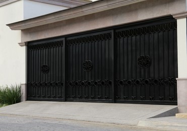 Photo of Closed metal gates of modern garage. Exterior design