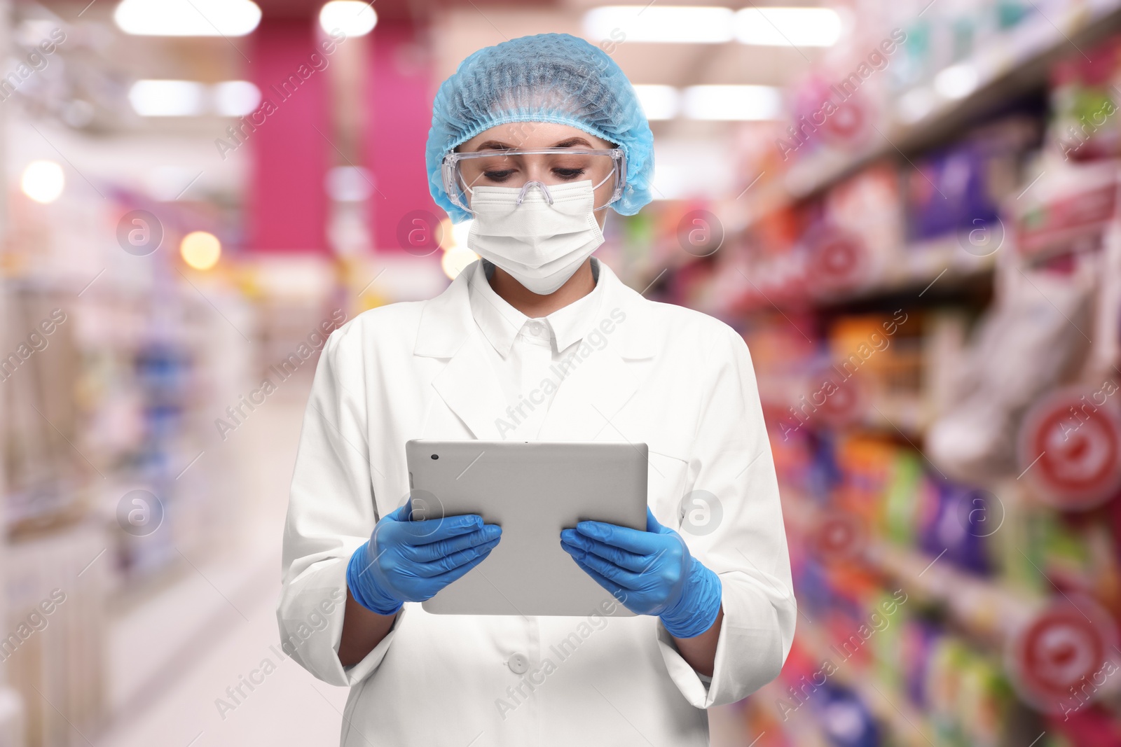 Image of Food quality control specialist examining products in supermarket