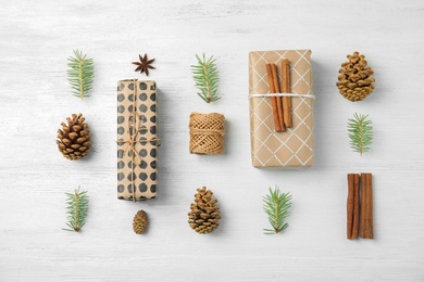 Photo of Flat lay Christmas composition with gift boxes on wooden background