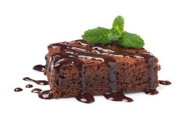 Photo of Delicious chocolate brownie with sweet syrup and fresh mint on white background