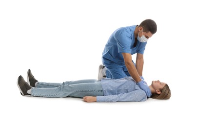 Photo of Doctor in uniform practicing first aid on woman against white background