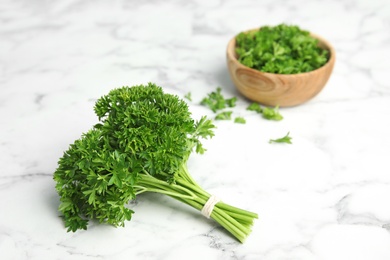 Photo of Fresh green parsley on marble table, space for text