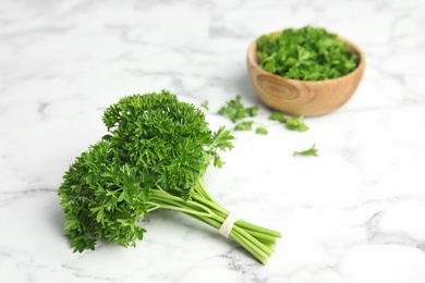 Fresh green parsley on marble table, space for text