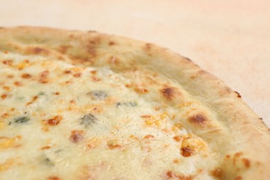 Photo of Delicious cheese pizza on beige table, closeup