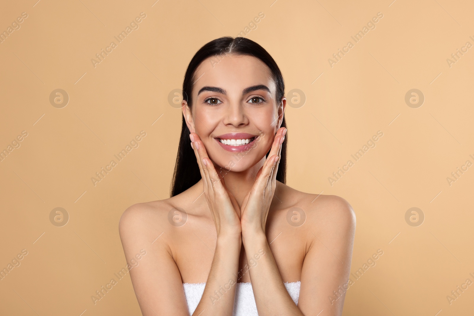 Photo of Portrait of attractive young woman on beige background. Spa treatment