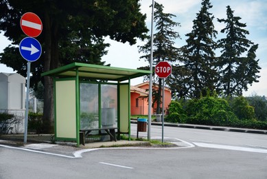 Photo of Posts with traffic signs near bus stop