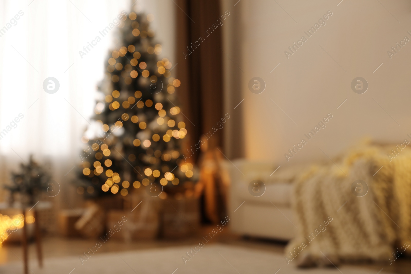 Photo of Beautiful living room interior with decorated Christmas tree and gifts, blurred view