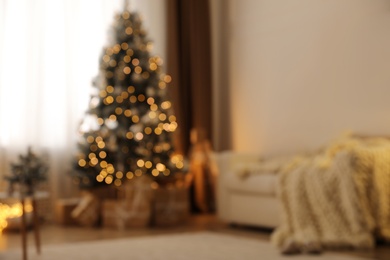 Photo of Beautiful living room interior with decorated Christmas tree and gifts, blurred view