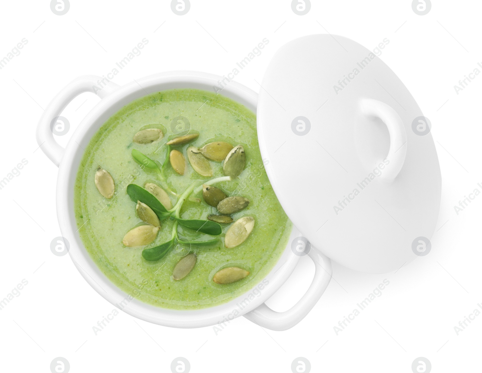 Photo of Delicious broccoli cream soup with pumpkin seeds isolated on white, top view