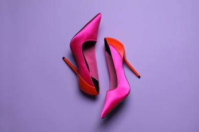 Photo of Pair of beautiful shoes on lilac background, top view