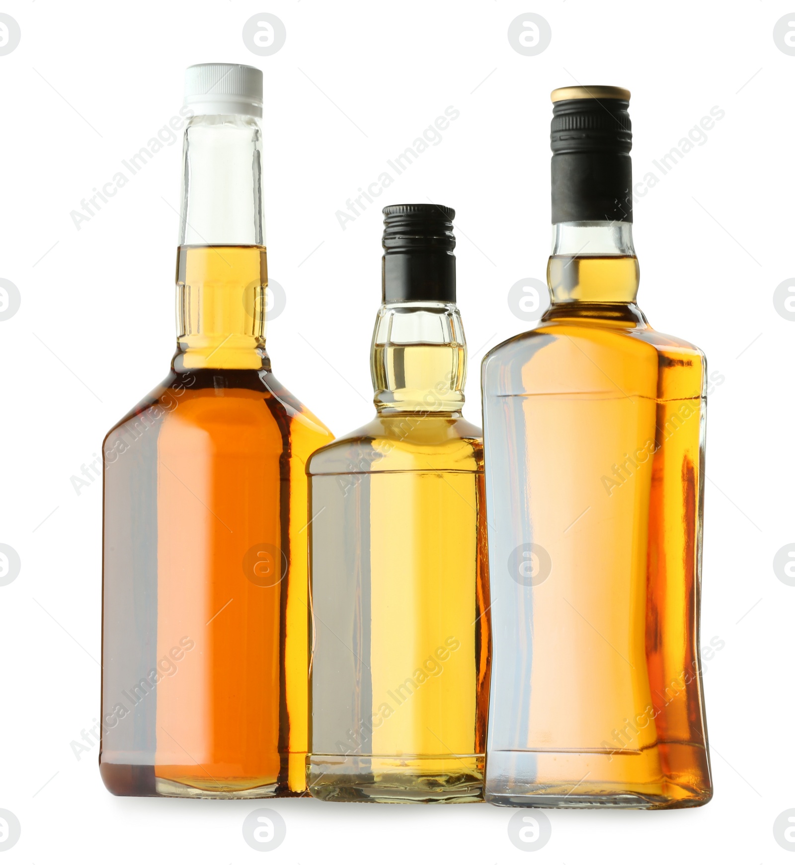 Photo of Different sorts of whiskey in glass bottles isolated on white