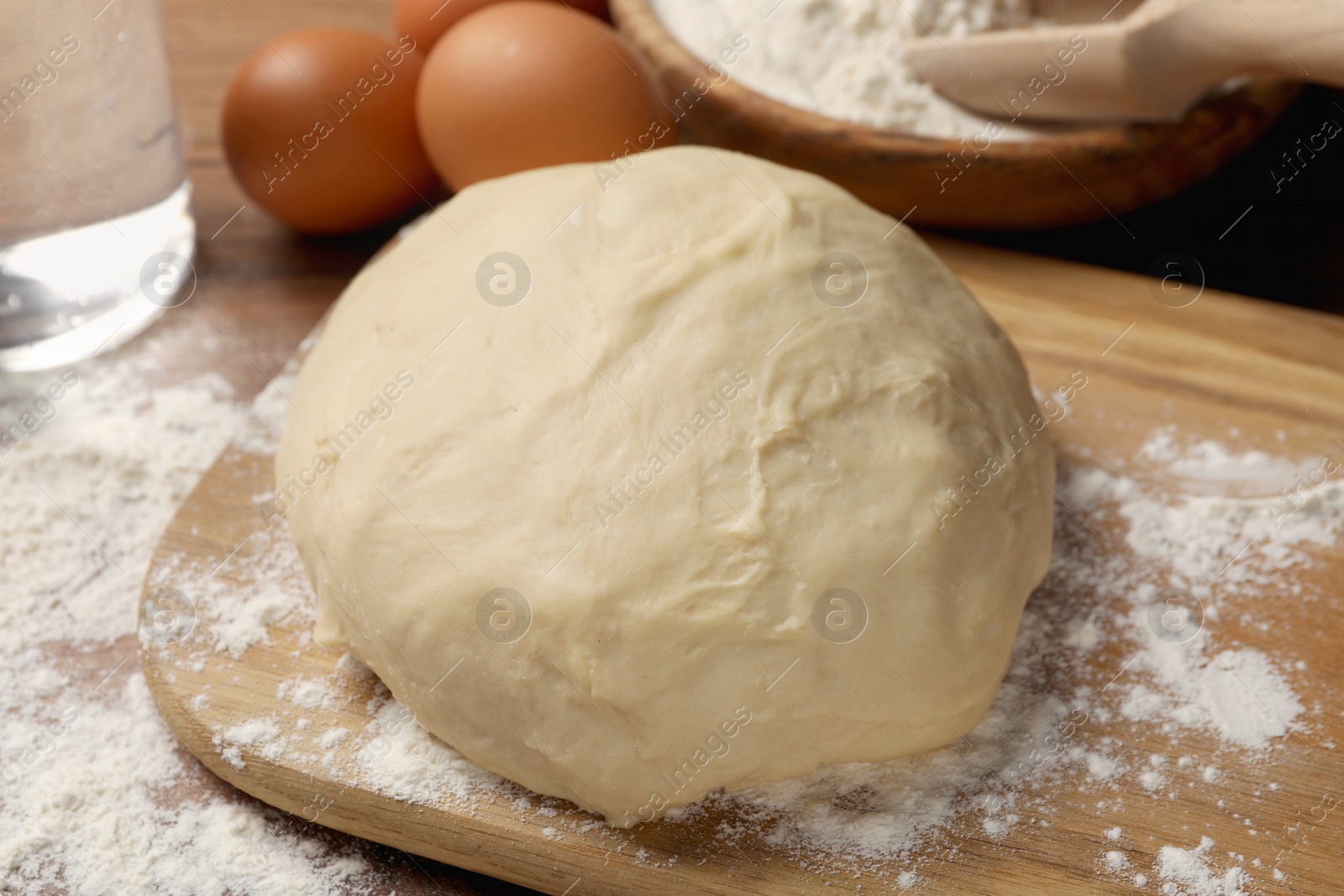 Photo of Cooking scones with soda water. Dough and ingredients on wooden table, closeup