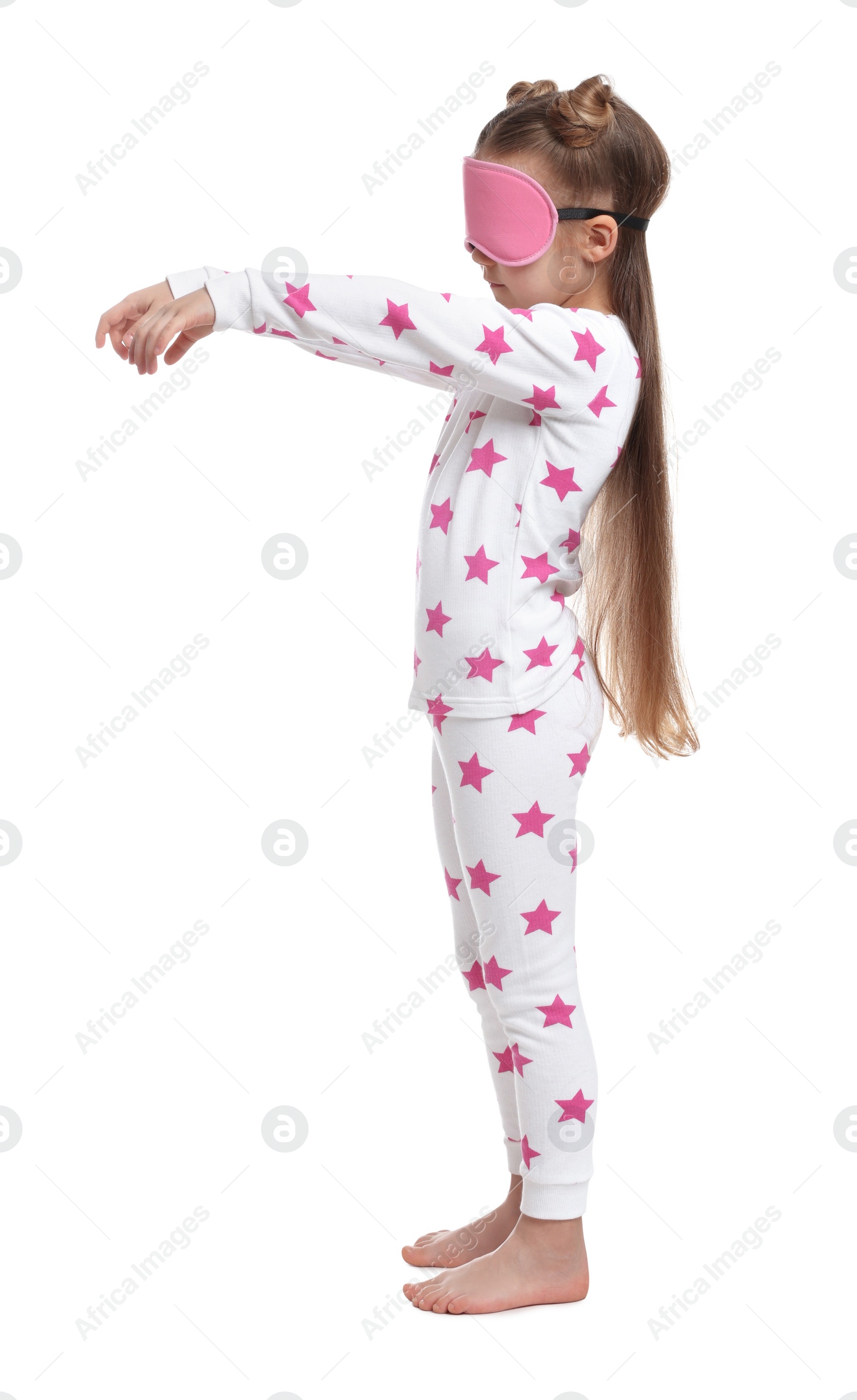 Photo of Girl in pajamas and sleep mask sleepwalking on white background