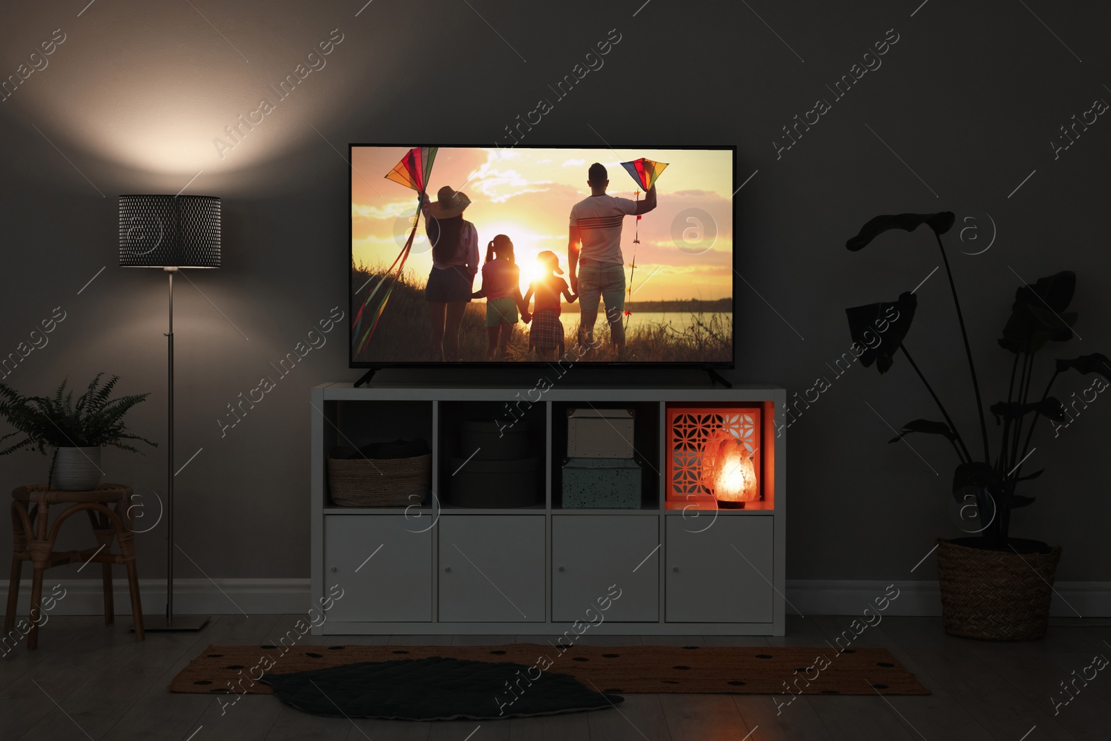 Image of Modern TV set on wooden stand in room