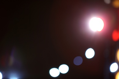 Photo of Blurred view of beautiful lights on dark background. Bokeh effect