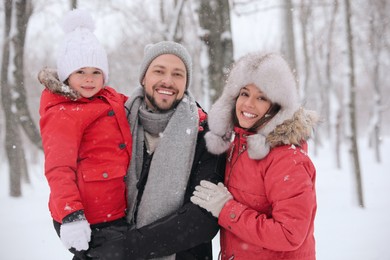 Portrait of happy family outside on winter day. Christmas vacation