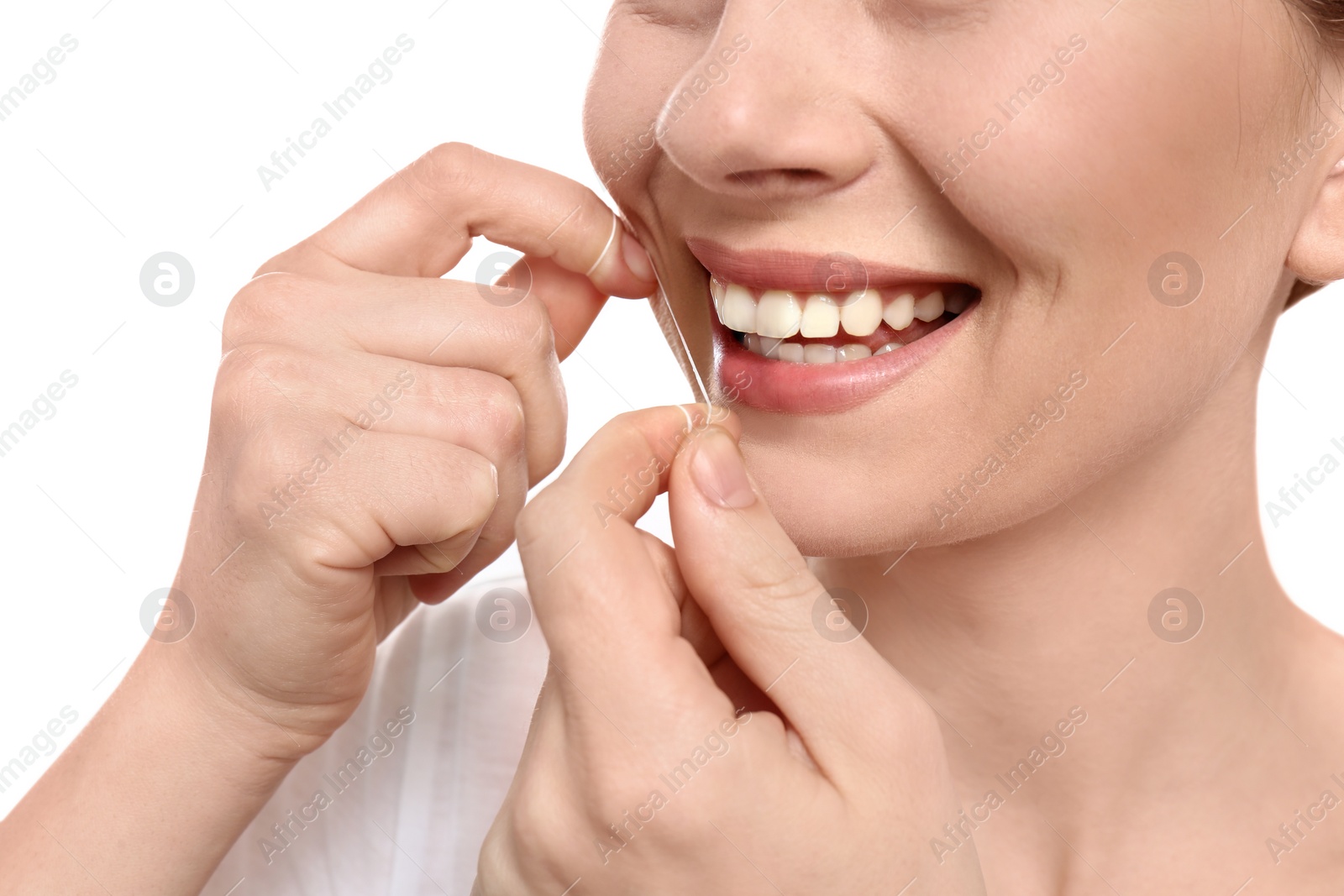 Photo of Young woman flossing her teeth on white background, closeup