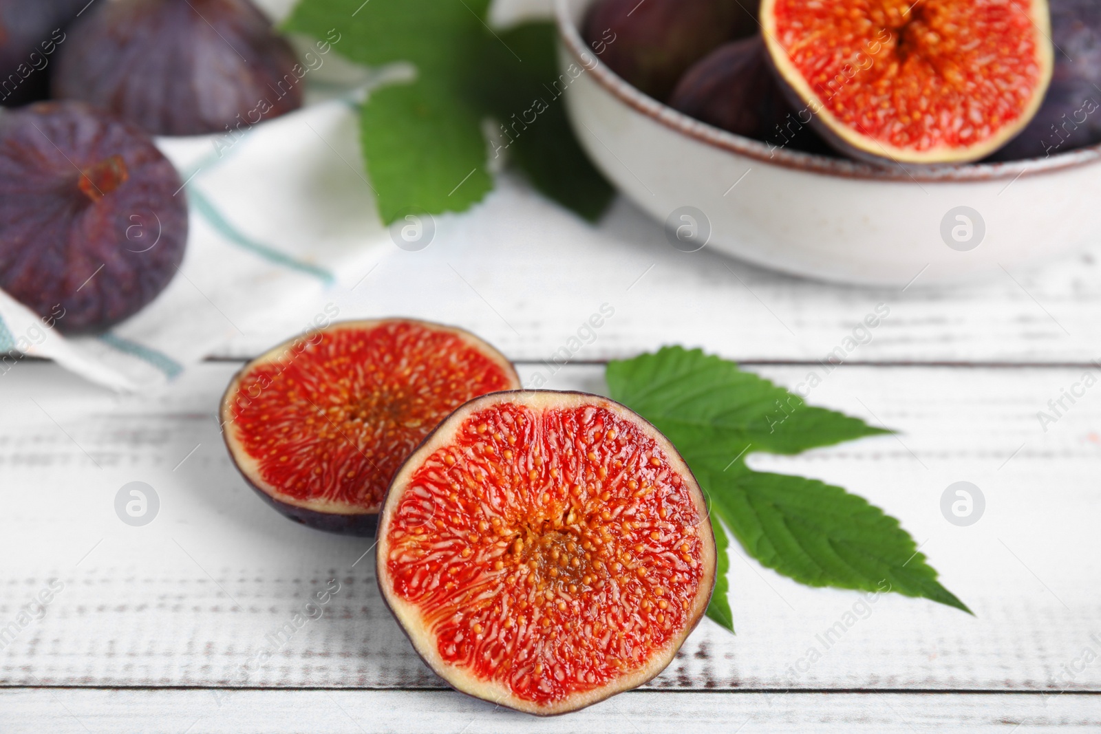 Photo of Fresh ripe figs on white wooden table