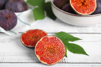 Fresh ripe figs on white wooden table