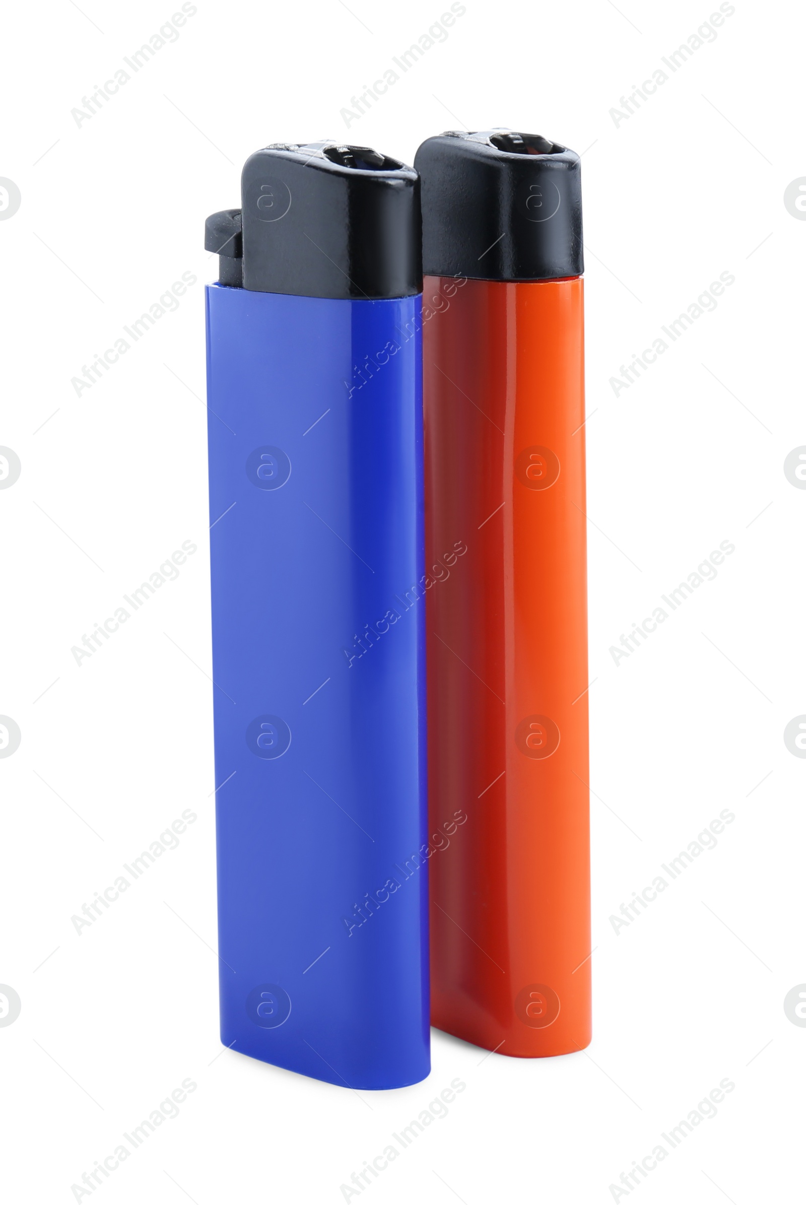 Photo of Stylish small pocket lighters on white background