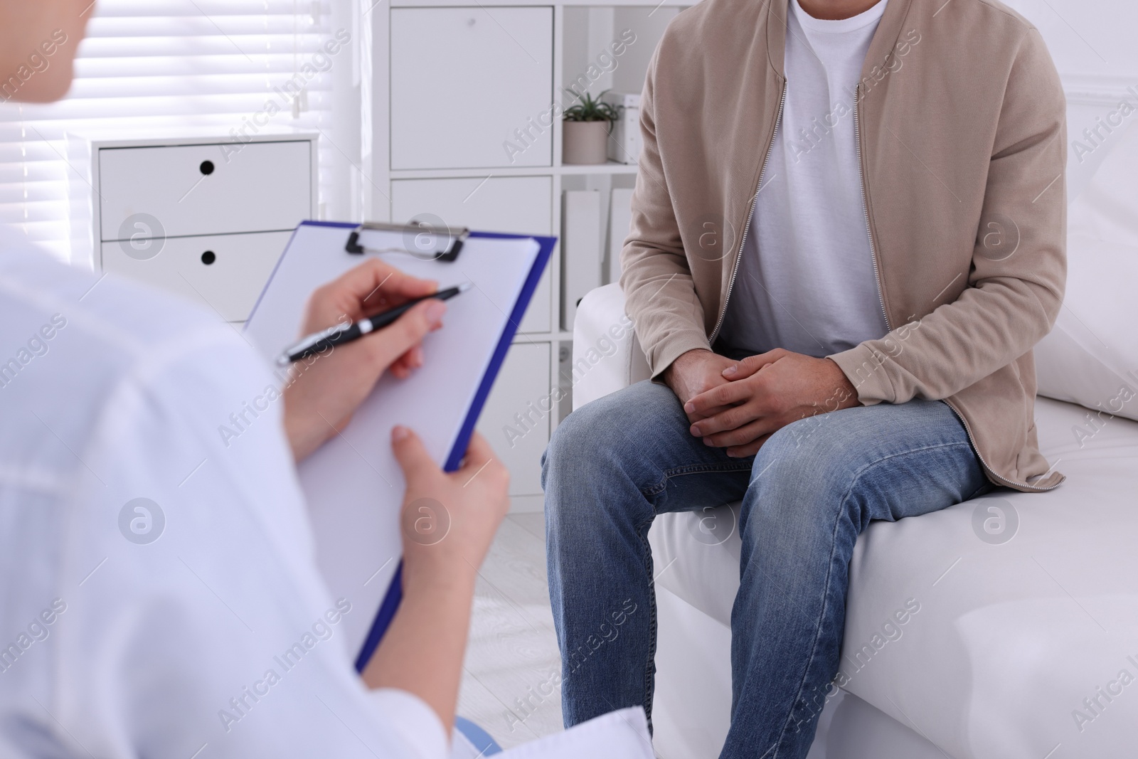 Photo of Man having appointment with STD specialist in clinic, closeup