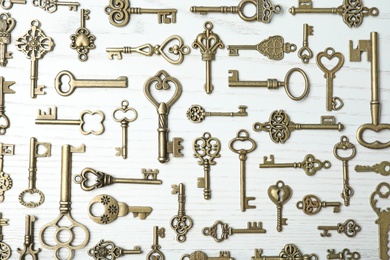 Photo of Flat lay composition with old vintage keys on wooden background