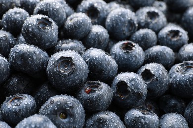 Wet fresh blueberries as background, closeup view