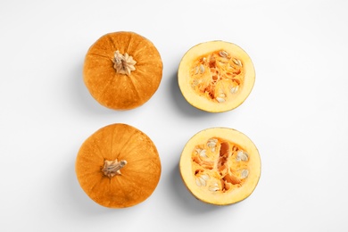 Fresh ripe pumpkins on white background, top view. Holiday decoration