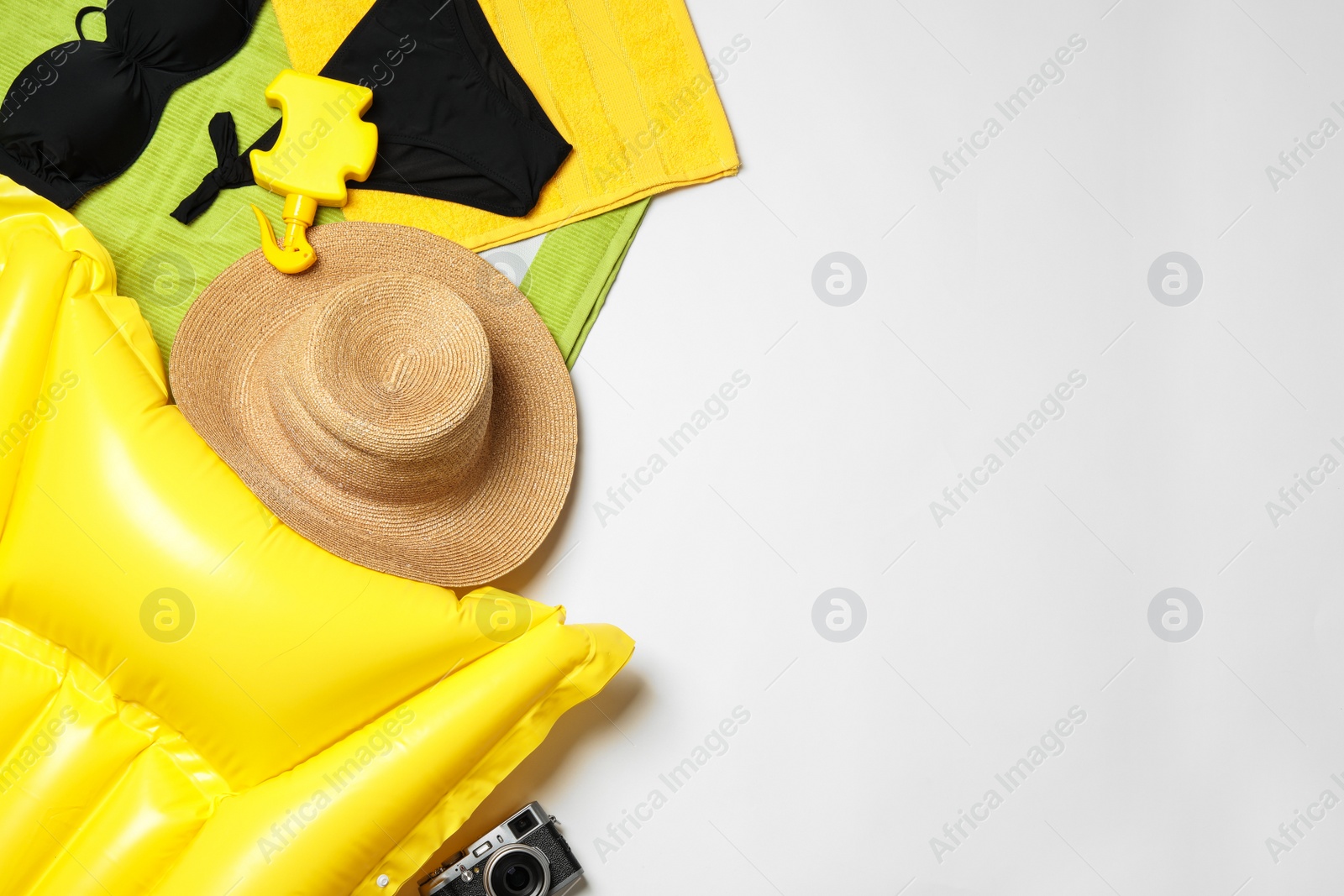 Photo of Flat lay composition with swimsuit and beach accessories on white background. Space for text