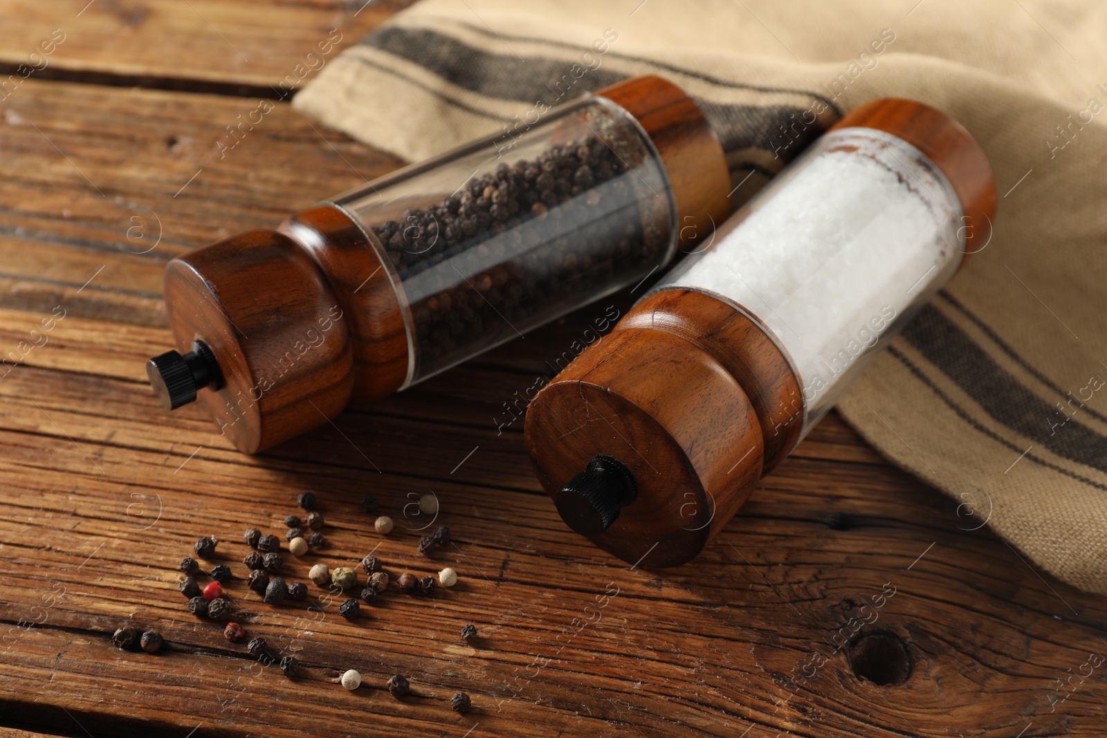 Photo of Salt and pepper shakers on wooden table