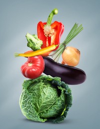 Stack of different fresh vegetables on light slate grey background