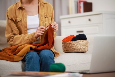 Photo of Teacher conducting online knitting course at home, closeup. Time for hobby