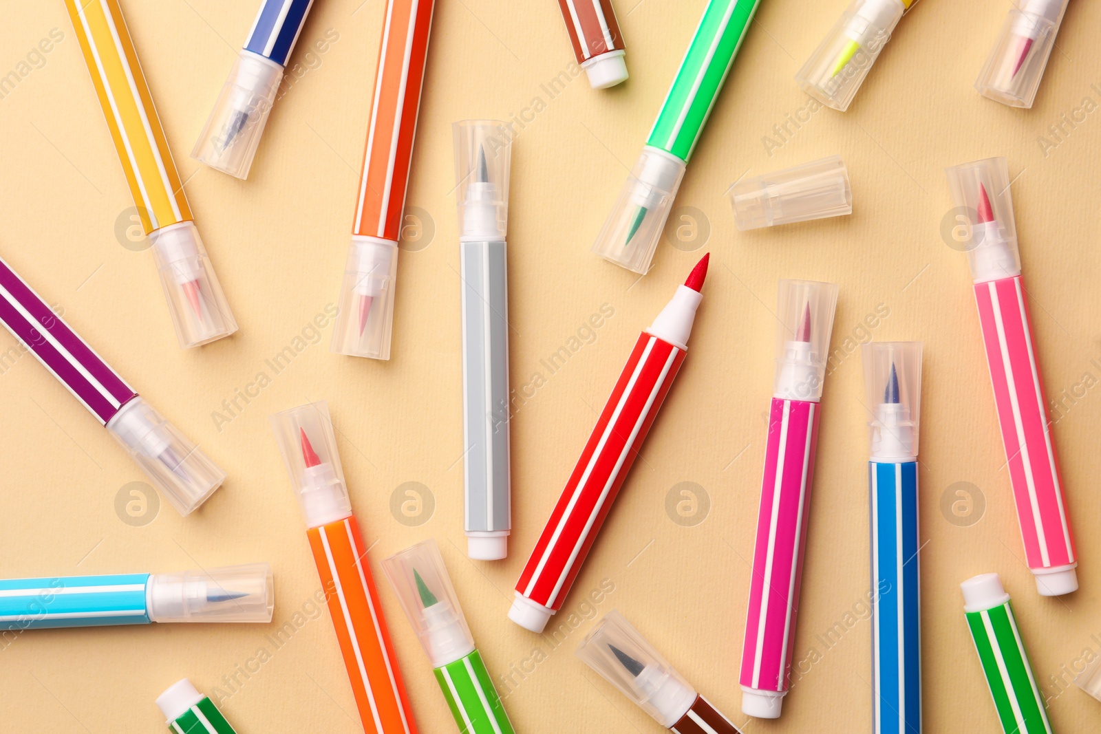 Photo of Many bright markers on beige background, flat lay