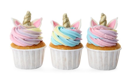 Photo of Three cute sweet unicorn cupcakes on white background