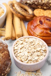 Photo of Different gluten free products on white marble table, closeup