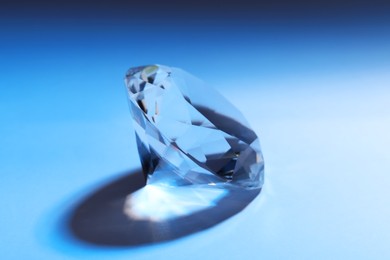 Photo of Beautiful dazzling diamond on blue gradient background