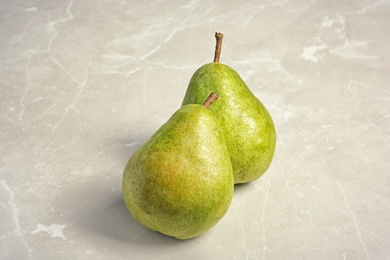 Photo of Tasty ripe green pears on grey background