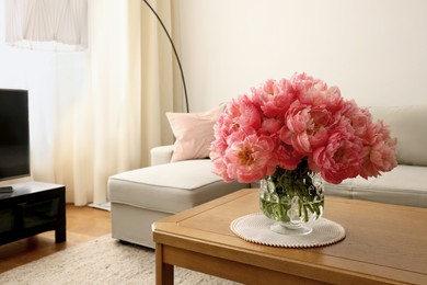 Beautiful pink peonies in vase on table at home, space for text. Interior design